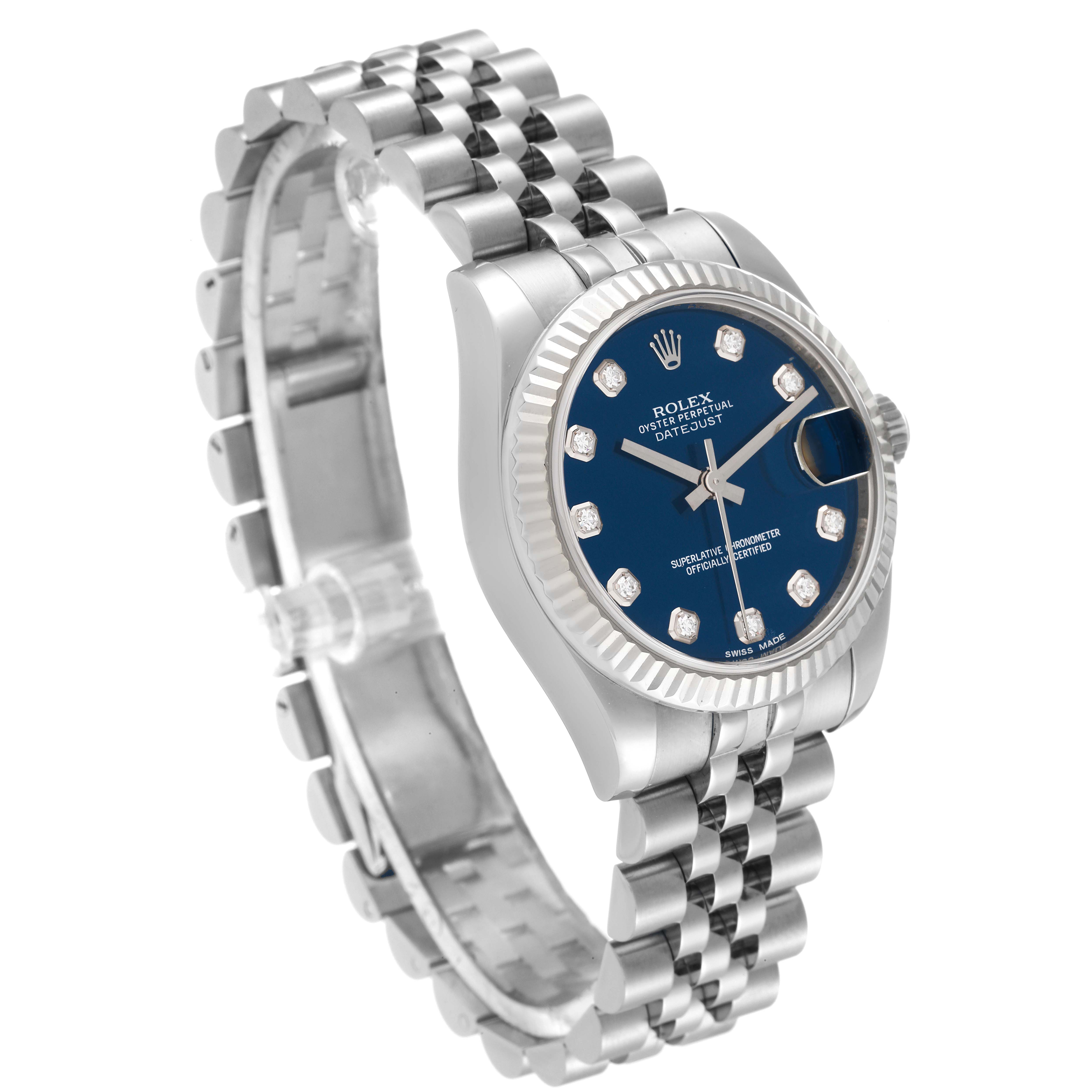 The image shows a side-angle view of a mid-size Rolex Datejust watch, highlighting its blue dial, diamond markers, fluted bezel, and jubilee bracelet.