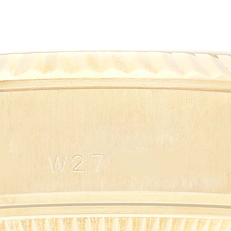 The image shows a close-up of the side and part of the bezel of a Rolex President 69178G Women
s Yellow Gold Champagne Dial 69178G Women
s Yellow Gold Champagne Dial model watch, with the engravings visible.