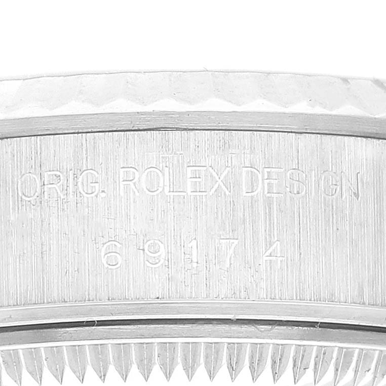 This image shows a close-up of the bezel and case of a Rolex Datejust 69174 Women's Stainless Steel Silver Dial 69174 Women's Stainless Steel Silver Dial watch, highlighting the model number "69174" and "ORIG. ROLEX DESIGN" engraving.