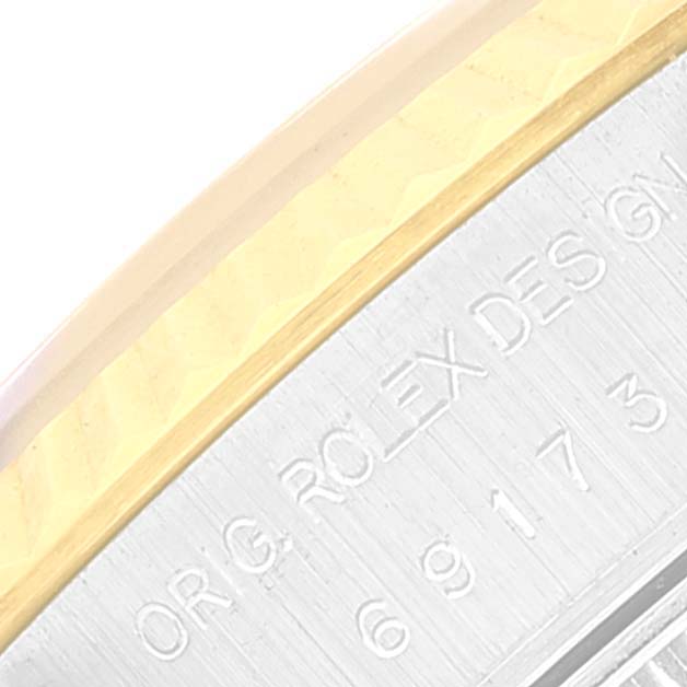 The image shows a close-up of the engraved edge of a Rolex Datejust 69173 Women's Steel and Gold (two tone) Beige Dial 69173 Women's Steel and Gold (two tone) Beige Dial watch, highlighting the bezel and part of the casing.