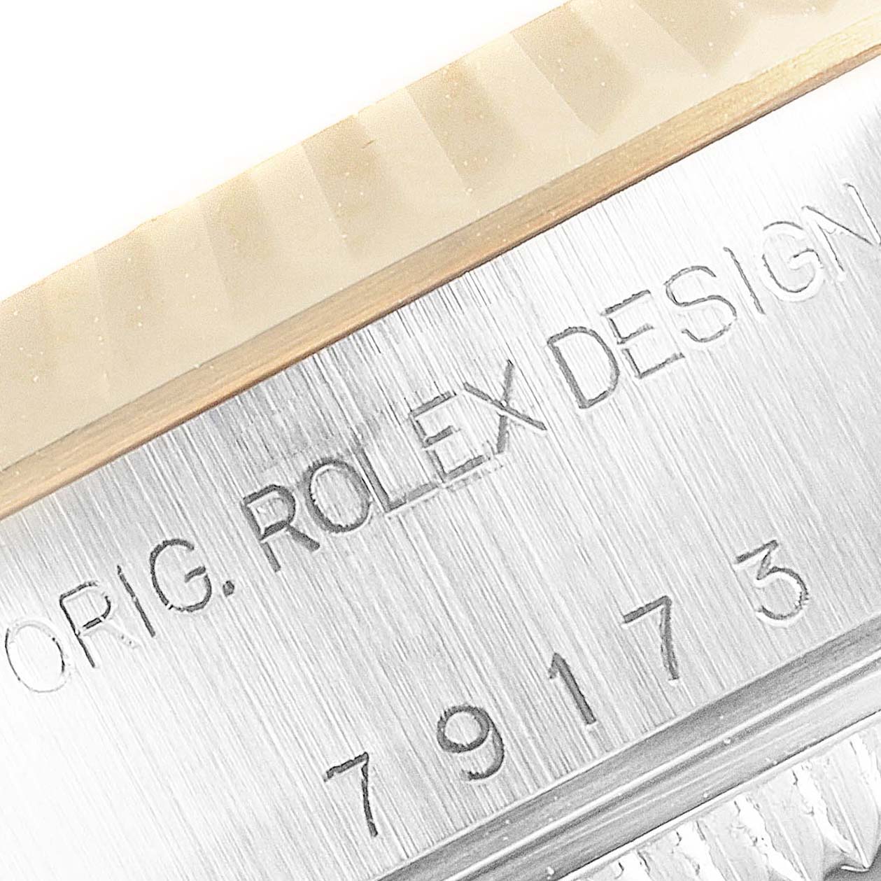 This image displays a close-up of the case side of a Rolex Datejust 79173 Women
s Steel and Gold (two tone) Beige Dial 79173 Women
s Steel and Gold (two tone) Beige Dial, showing the "ORIG. ROLEX DESIGN" engraving and model number.