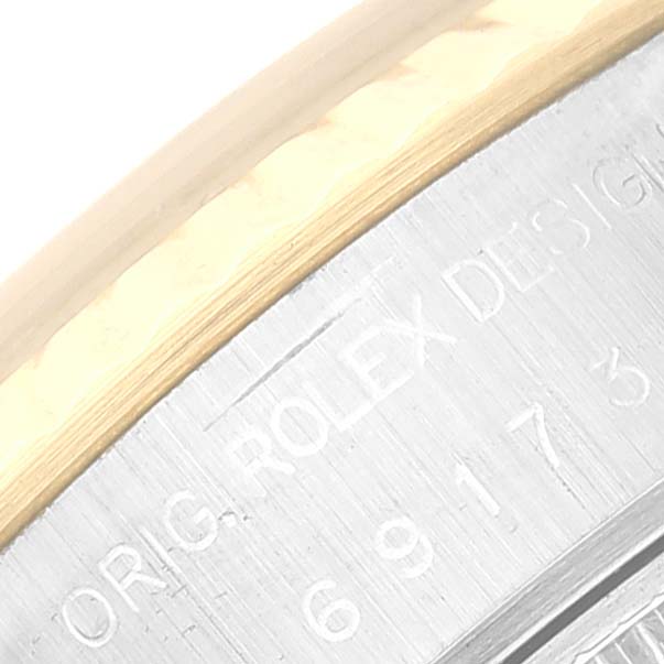 The image shows a close-up of the detailed engraving on the side of the Rolex Datejust 69173 Women's Steel and Gold (two tone) Champagne Dial 69173 Women's Steel and Gold (two tone) Champagne Dial watch case.
