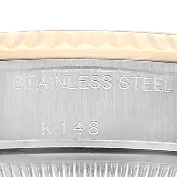 The image shows a close-up of the side of a Rolex Datejust 79173 Women's Steel and Gold (two tone) Champagne Dial 79173 Women's Steel and Gold (two tone) Champagne Dial watch, highlighting the "STAINLESS STEEL" engraving and part of the bezel.