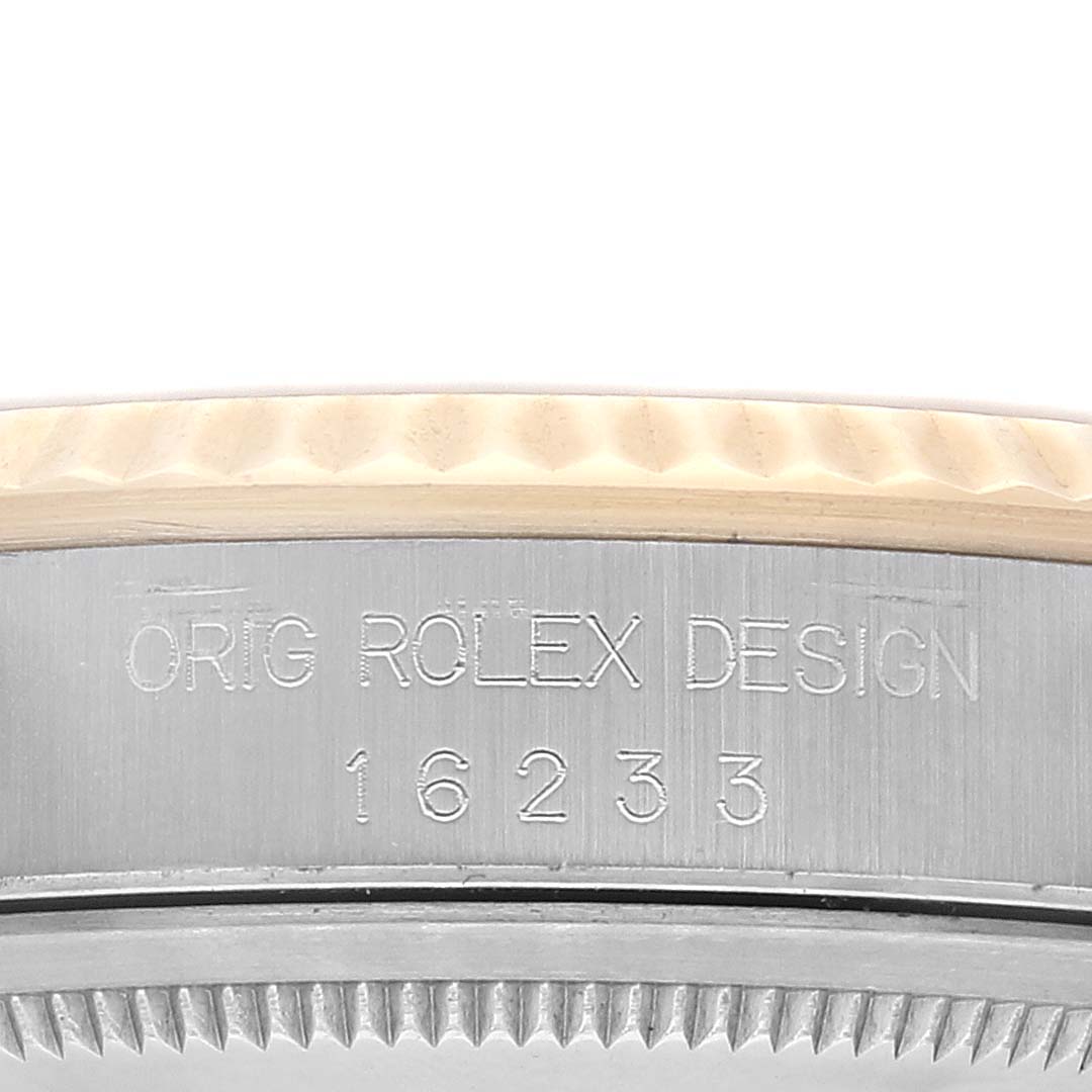The image shows a close-up of the side of the case of a Rolex Datejust 16233 Men's Steel and Gold (two tone) Champagne Dial 16233 Men's Steel and Gold (two tone) Champagne Dial watch, displaying the model number 16233 and "ORIG ROLEX DESIGN" engraving.