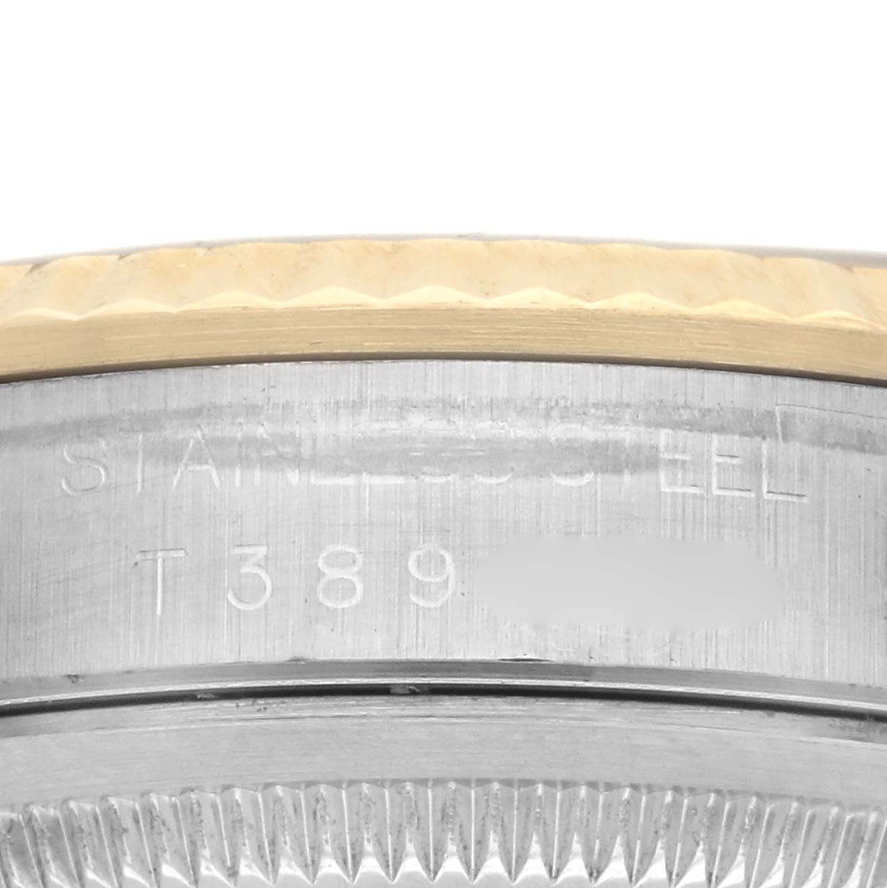 The image shows a close-up of the edge and side engraving on the Rolex Datejust 16233 Men's Steel and Gold (two tone) Champagne Dial 16233 Men's Steel and Gold (two tone) Champagne Dial watch case, highlighting the bezel and serial number.