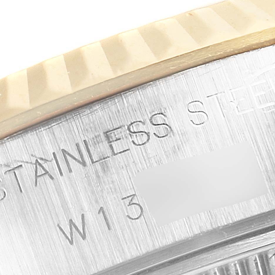 This close-up image shows the side engraving and part of the bezel of a Rolex Datejust 69173 Women's Steel and Gold (two tone) Champagne Dial 69173 Women's Steel and Gold (two tone) Champagne Dial watch.