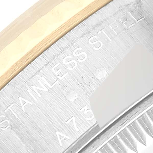 This image shows a close-up of the stainless steel and gold bezel with part of the serial number on a Rolex Datejust 79173 Women's Steel and Gold (two tone) White Dial 79173 Women's Steel and Gold (two tone) White Dial model.