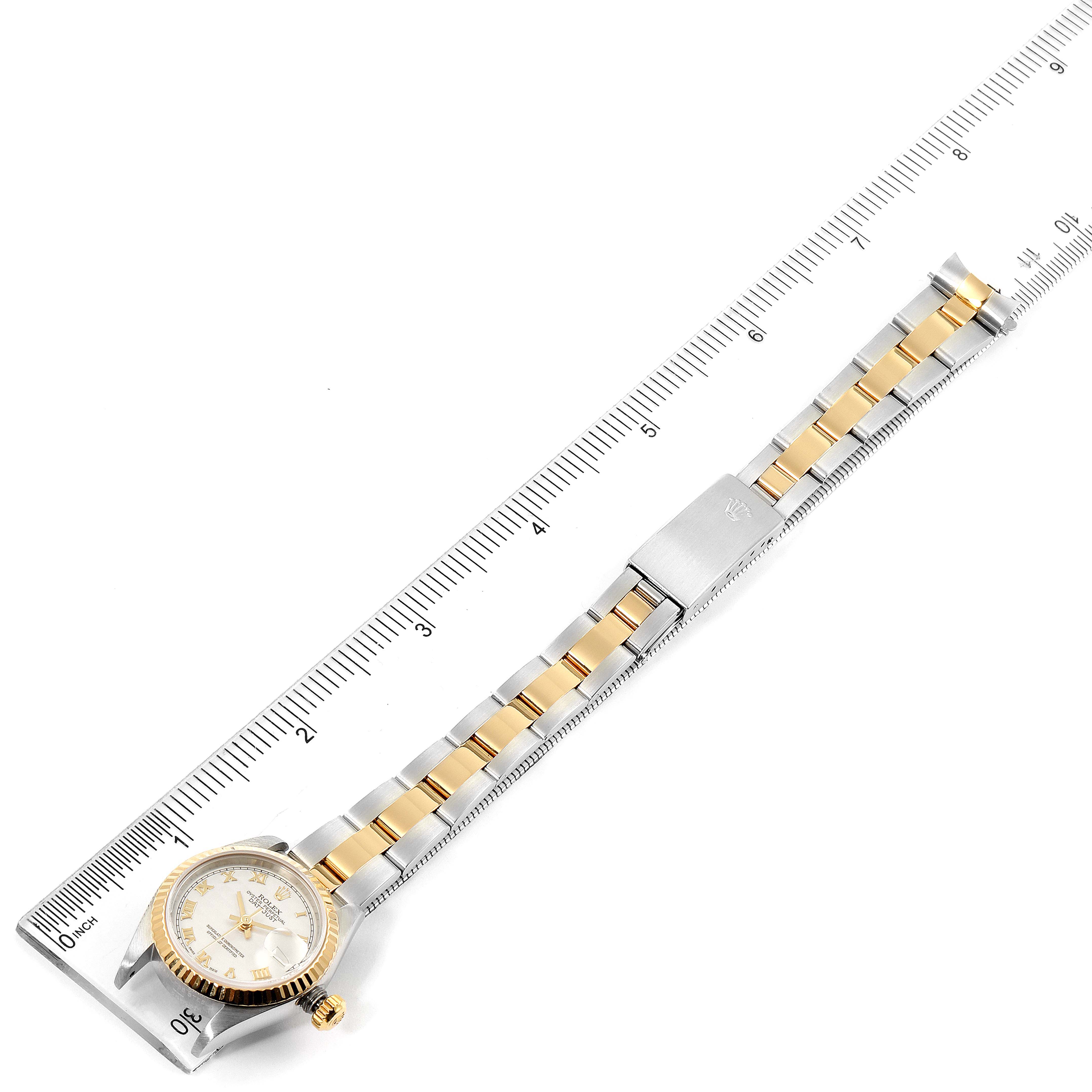 The Rolex Datejust 79173 Women's Steel and Gold (two tone) Silver Dial 79173 Women's Steel and Gold (two tone) Silver Dial watch is shown at an angle with the face, bezel, crown, and bracelet visible, alongside a measuring ruler.