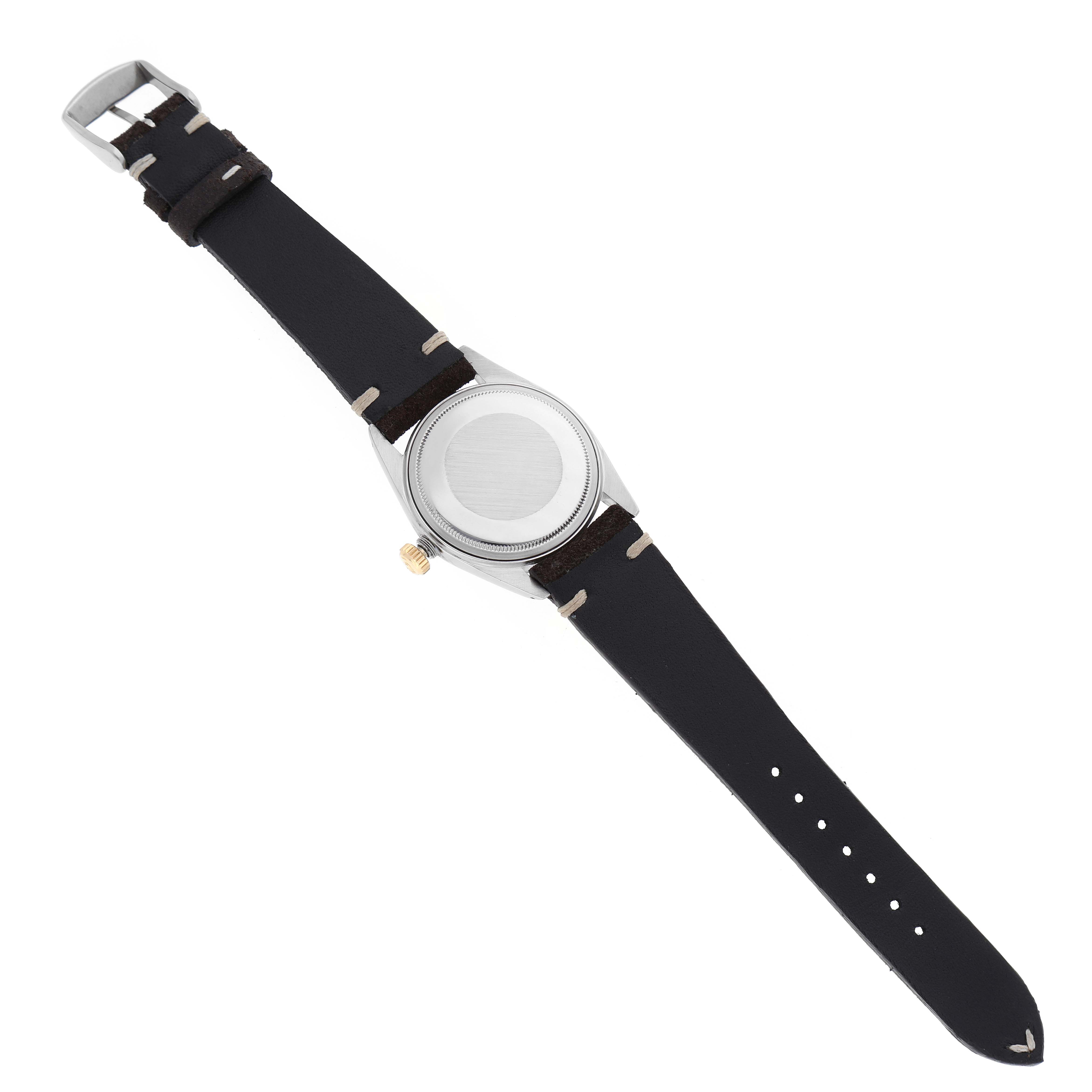 The image shows the back view of a Rolex Vintage Collection 1601 Men's Steel and Gold (two tone) Silver Dial 1601 Men's Steel and Gold (two tone) Silver Dial watch, including the case, crown, and leather straps.