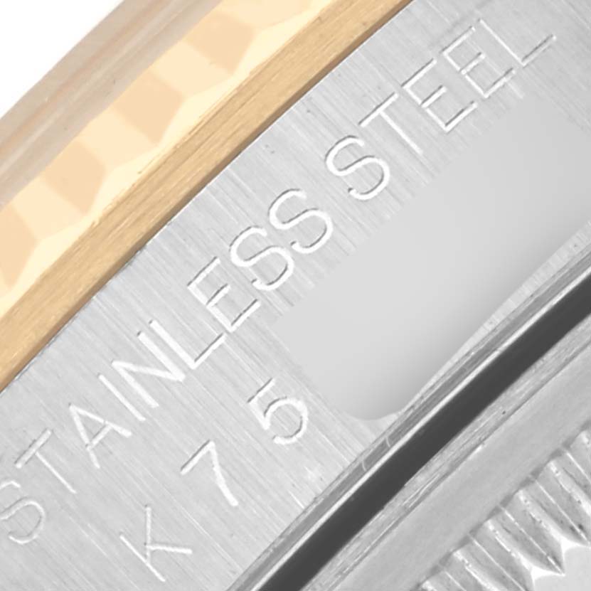 The image shows a close-up of the Rolex Datejust 16233 Men's Steel and Gold (two tone) Grey Dial 16233 Men's Steel and Gold (two tone) Grey Dial's stainless steel and gold bezel with engraved text.