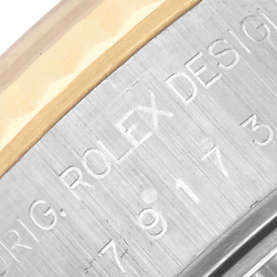 This is a close-up of the side of a Rolex Datejust 79173 Women's Steel and Gold (two tone) White Dial 79173 Women's Steel and Gold (two tone) White Dial, showing the engraved case details.