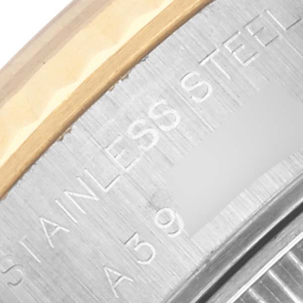 The image shows a close-up of the side of a Rolex Datejust 79173 Women's Steel and Gold (two tone) White Dial 79173 Women's Steel and Gold (two tone) White Dial, focusing on the stainless steel case with engravings.