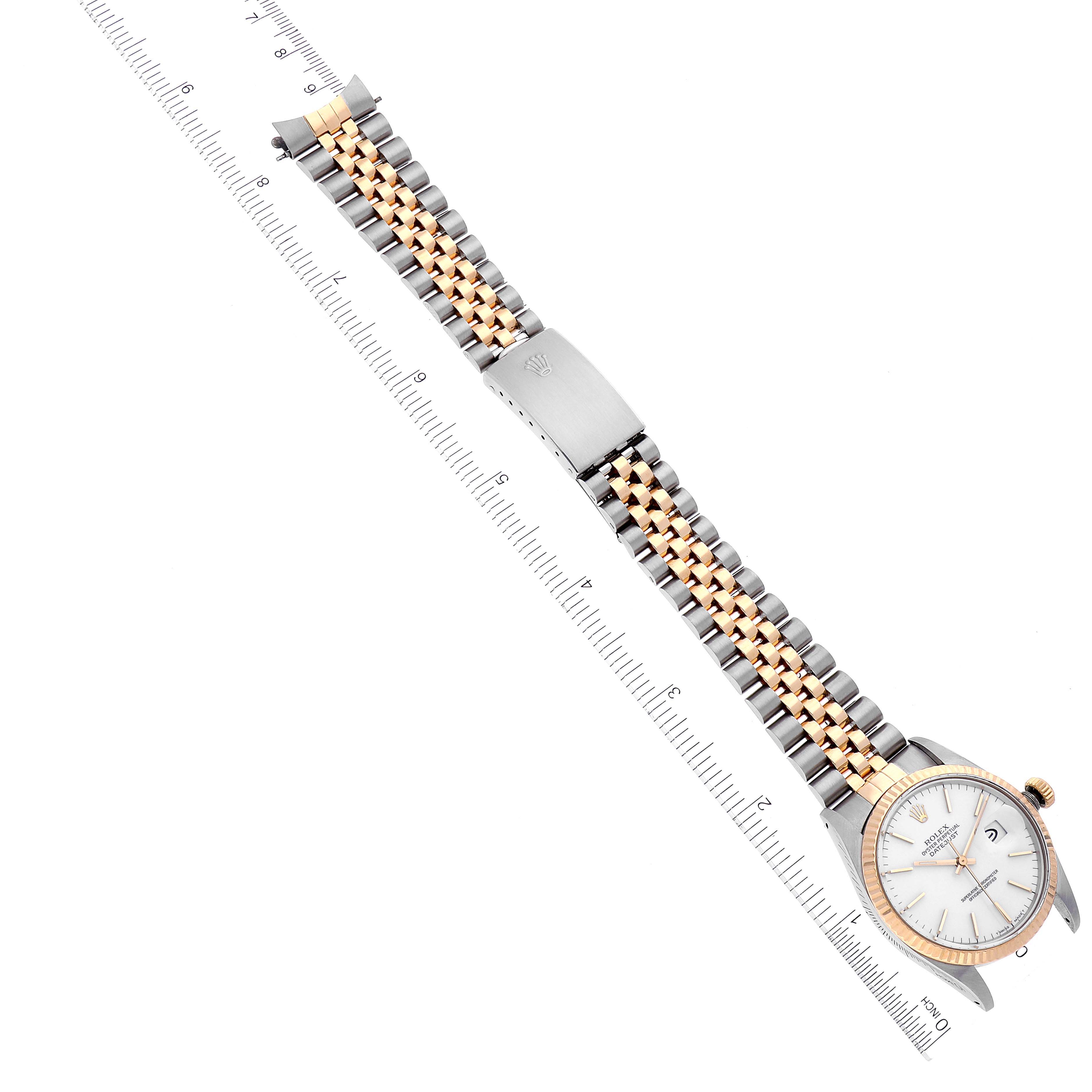 The image shows a Rolex Datejust 16013 Men's Steel and Gold (two tone) White Dial 16013 Men's Steel and Gold (two tone) White Dial watch laid flat with the full band and face, alongside a ruler for scale.