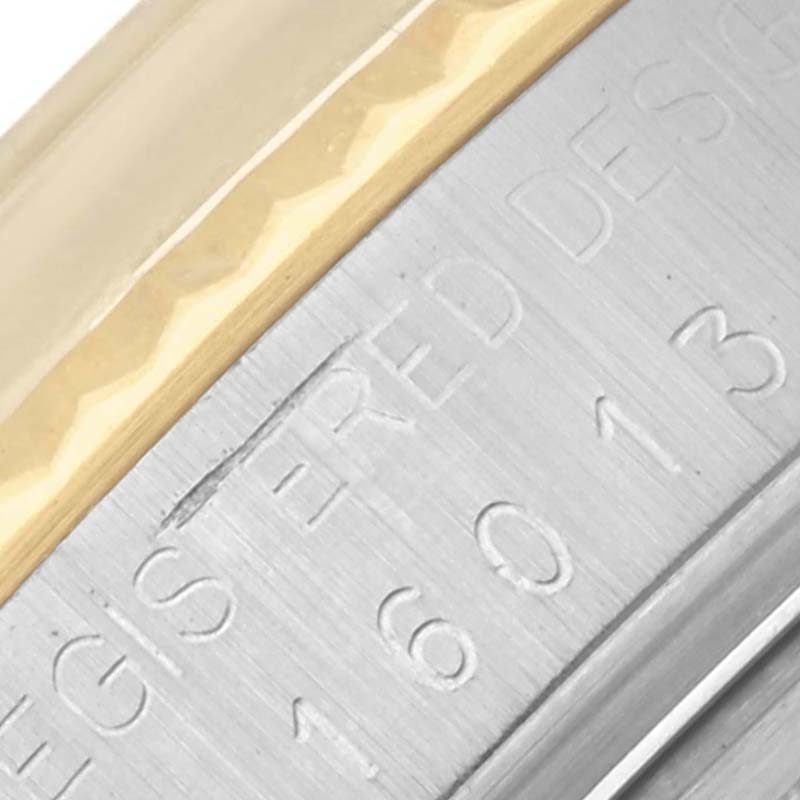 The image shows a close-up of the Rolex Vintage Collection 16013 Men's Steel and Gold (two tone) White Dial 16013 Men's Steel and Gold (two tone) White Dial's bezel and engraved watch case.
