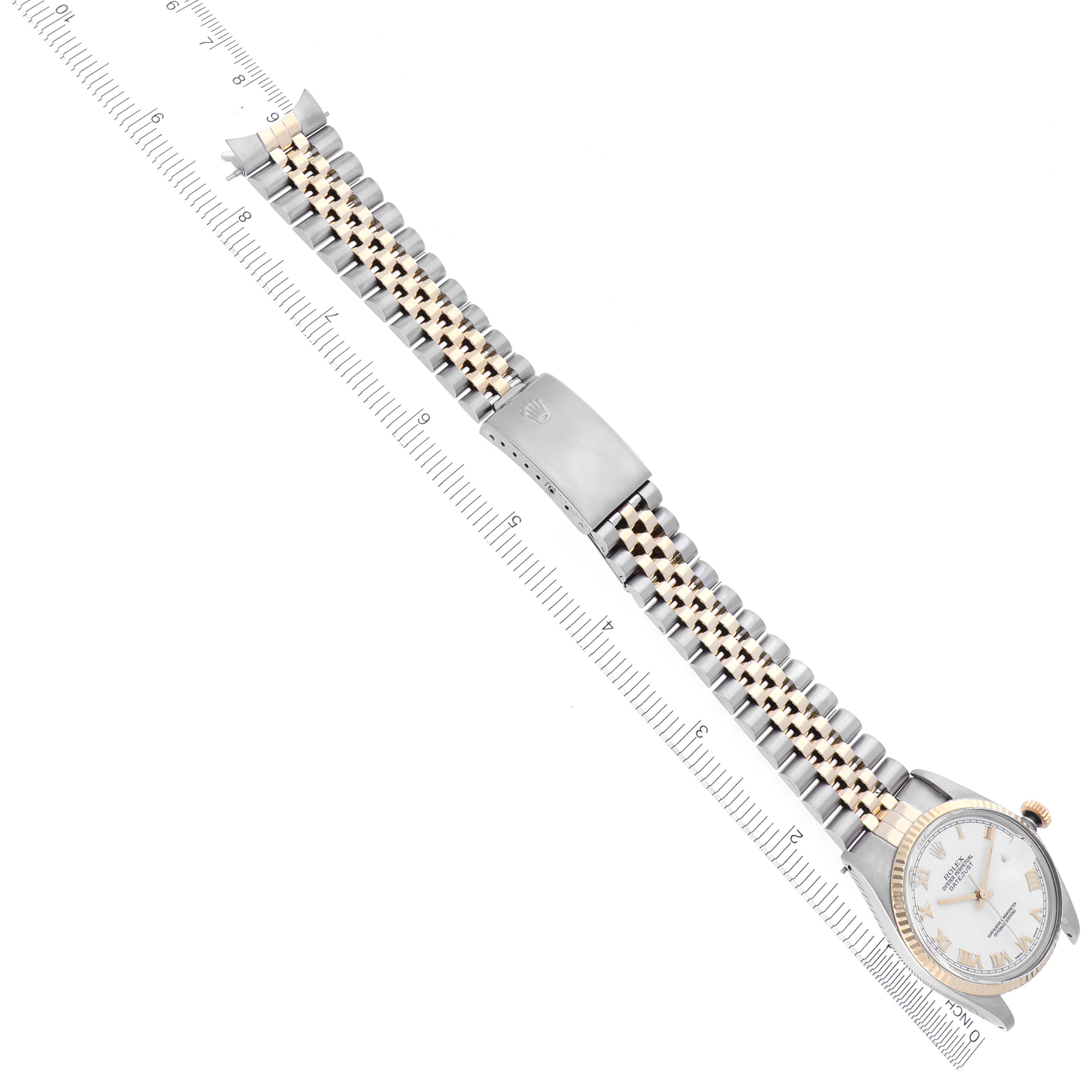 The Rolex Vintage Collection 16013 Men's Steel and Gold (two tone) White Dial 16013 Men's Steel and Gold (two tone) White Dial watch is shown from a top view, displaying the full bracelet and face alongside a ruler.