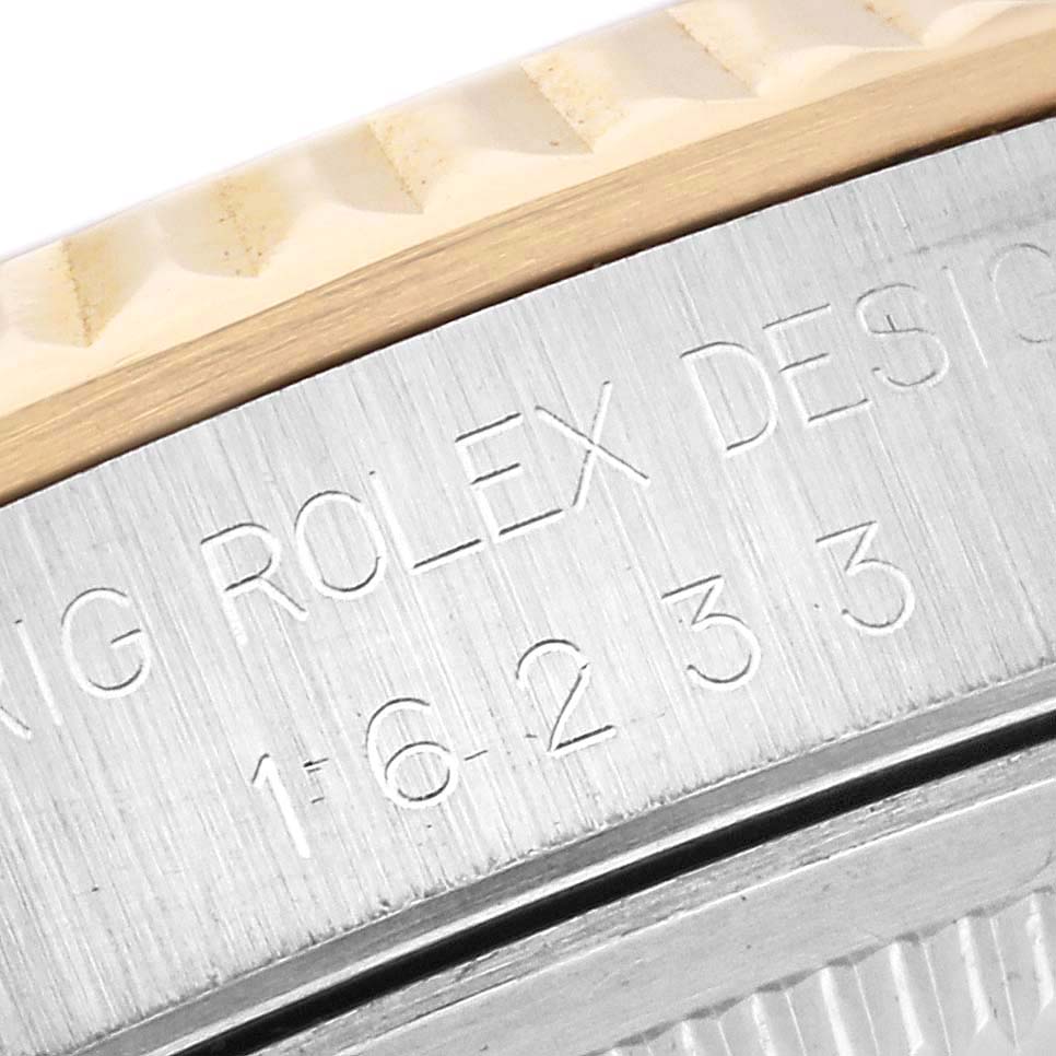 The image shows a close-up of the Rolex Datejust 16233 Men's Steel and Gold (two tone) White Dial 16233 Men's Steel and Gold (two tone) White Dial model, focusing on the engraved bezel and part of the case.