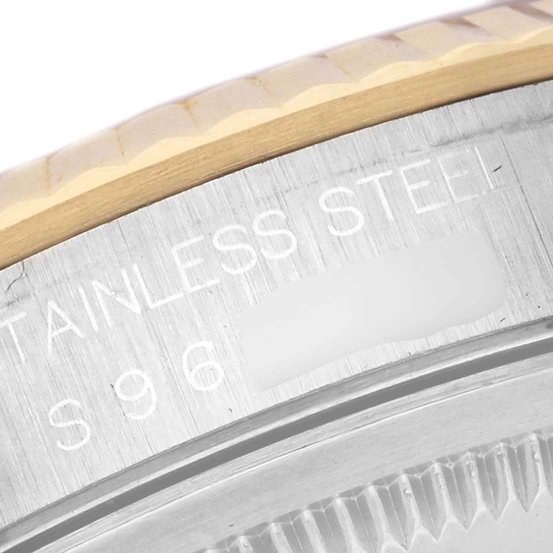 The image shows the side of a Rolex Datejust 16233 Men's Steel and Gold (two tone) White Dial 16233 Men's Steel and Gold (two tone) White Dial, focusing on the fluted bezel and engraved edge.