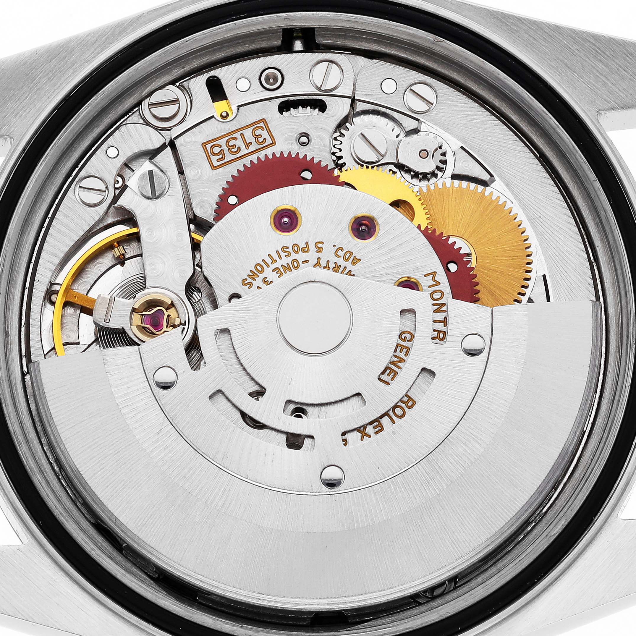 The image shows a close-up of the Rolex Datejust 16233 Men's Steel and Gold (two tone) White Dial 16233 Men's Steel and Gold (two tone) White Dial's movement, highlighting gears and the oscillating weight.