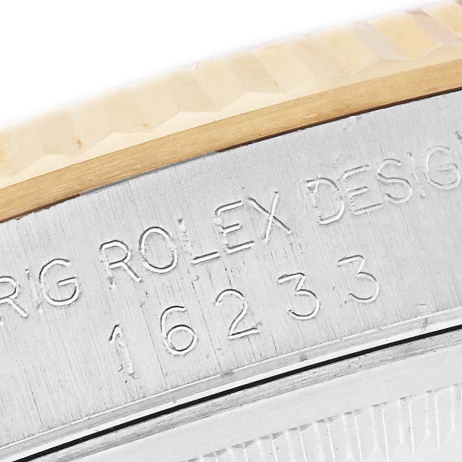 The image shows a close-up of the engraved side of the bezel and case of the Rolex Datejust 16233 Men's Steel and Gold (two tone) White Dial 16233 Men's Steel and Gold (two tone) White Dial model.