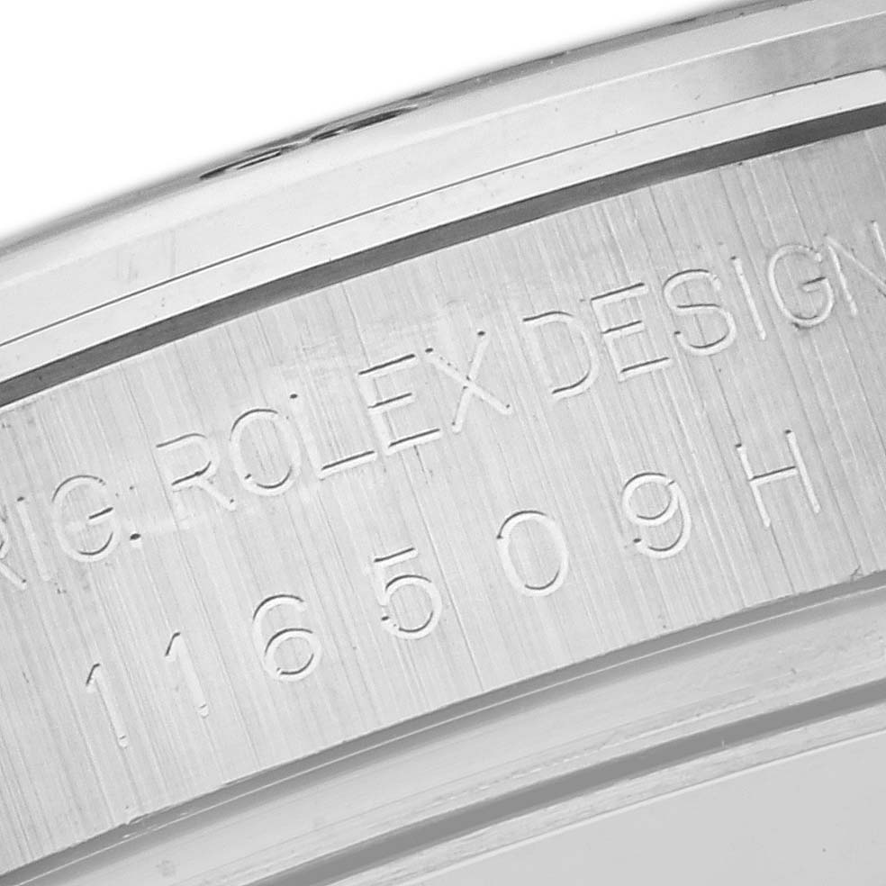 The image shows an angled close-up of the inner case engraving on the Rolex Daytona 116509 Men's White Gold Blue Dial 116509 Men's White Gold Blue Dial, featuring model and design markings.
