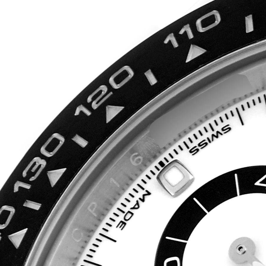 The image shows a close-up of the bezel and part of the dial of a Rolex Daytona 116500LN Men's Stainless Steel White Dial 116500LN Men's Stainless Steel White Dial watch, focusing on the tachymetric scale.