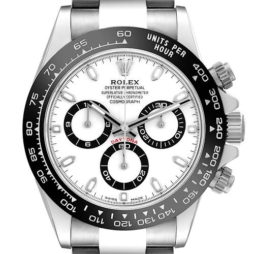 The Rolex Daytona watch is shown from a top-down angle, displaying the face, bezel, crown, and pushers.