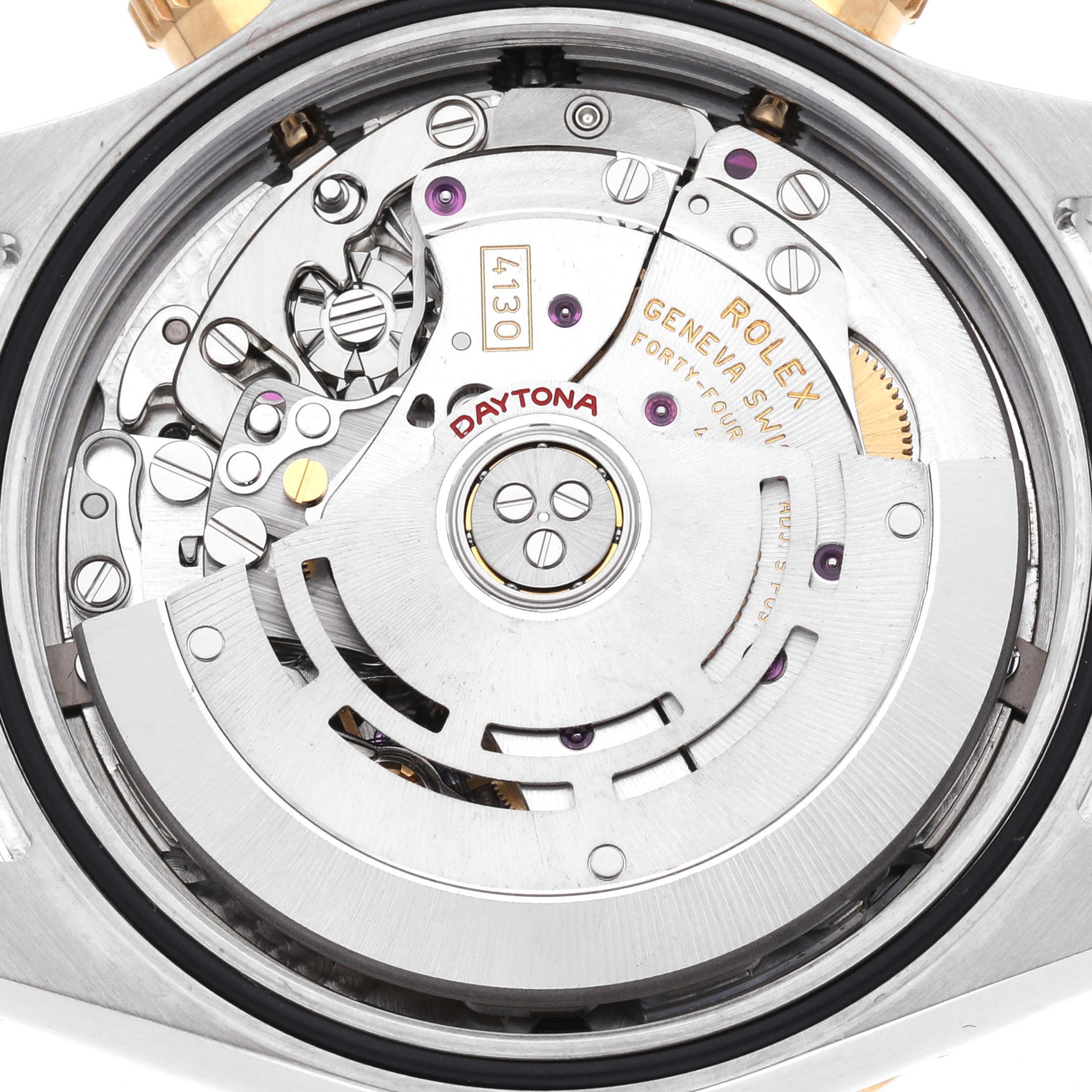The image shows the movement from the back of a Rolex Daytona 116523 Men's Steel and Gold (two tone) Silver Dial watch, revealing intricate gears and components.