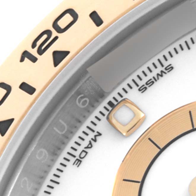 The image shows a close-up of the Rolex Daytona 116503 Men's Steel and Gold (two tone) White Dial 116503 Men's Steel and Gold (two tone) White Dial watch's bezel, partial dial, and hour markers.