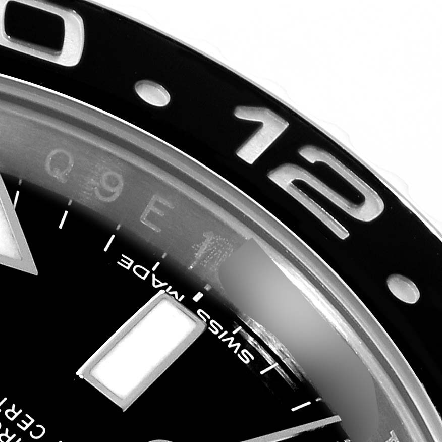 The image shows a close-up of the bezel, hour marker, and part of the dial of a Rolex GMT-Master 116710 Men's Stainless Steel Black Dial 116710 Men's Stainless Steel Black Dial watch.