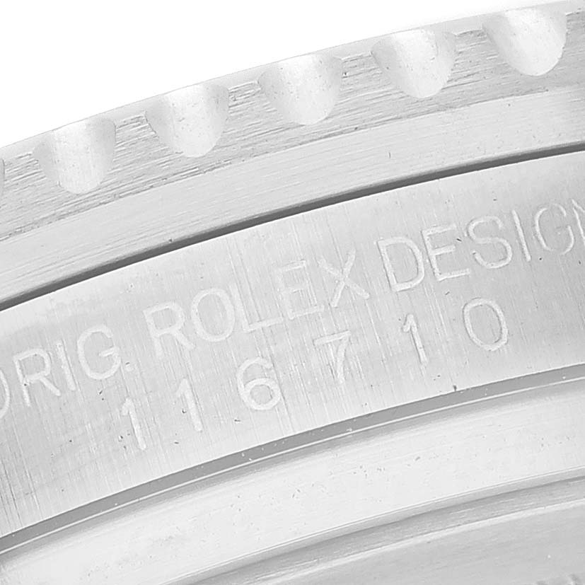 This close-up image shows the engraved serial number and caseback edge of a Rolex GMT-Master 116710 Men's Stainless Steel Black Dial 116710 Men's Stainless Steel Black Dial watch.