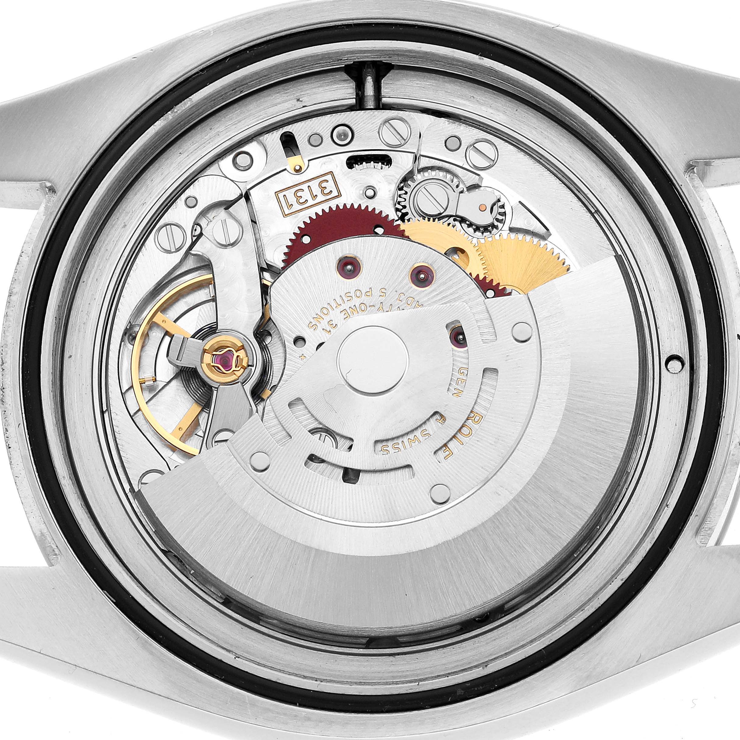 The image shows the internal mechanism of a Rolex Milgauss 116400 Men's Stainless Steel Black Dial watch, viewed from the back, displaying its gears and rotor.