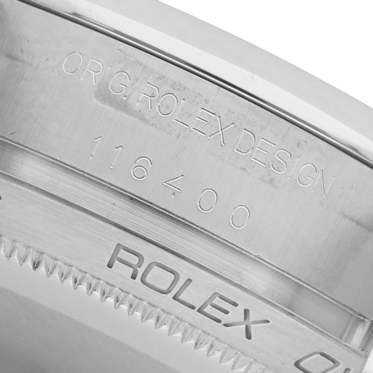 The image shows a close-up of the case back edge and engraving on a Rolex Milgauss 116400 Men's Stainless Steel Black Dial watch, displaying the model number.