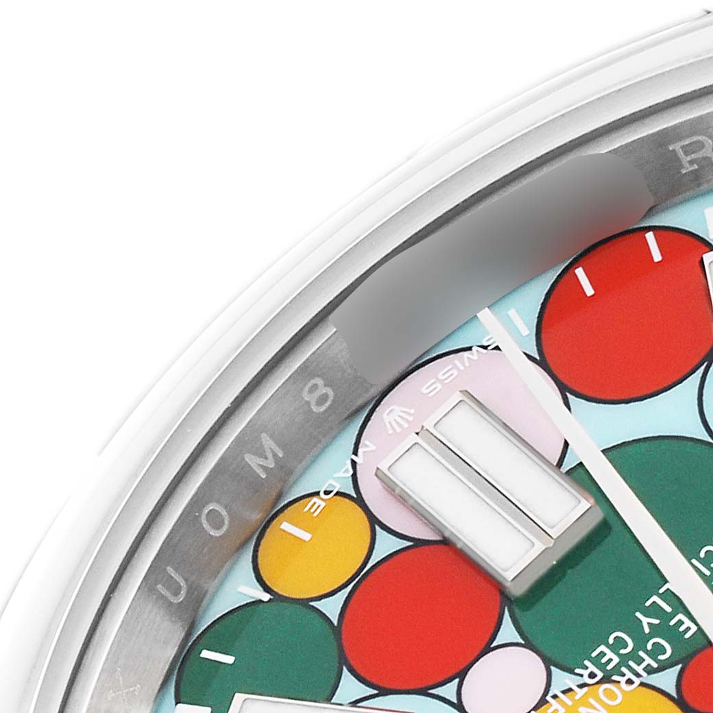 The image shows a close-up of the dial and part of the bezel of a Rolex Oyster Perpetual 124300 Men
s Stainless Steel Blue Dial 124300 Men
s Stainless Steel Blue Dial watch, featuring a colorful circular design.