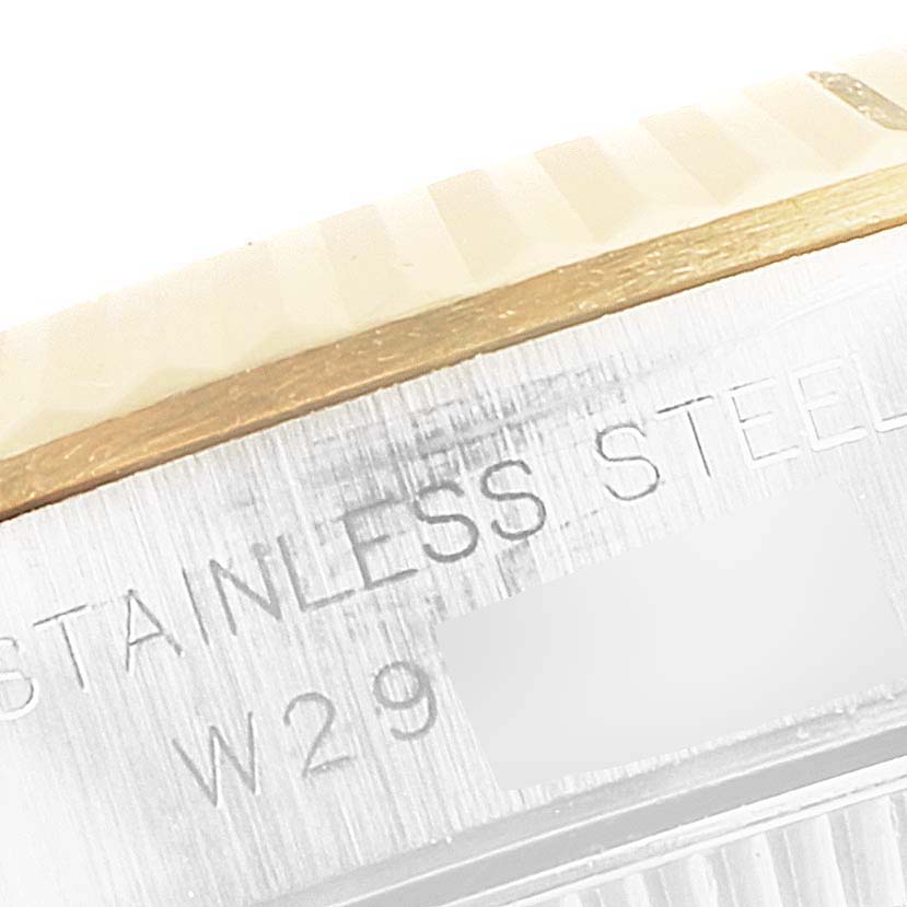 This image shows a close-up of the case side of a Rolex Oyster Perpetual 67193 Women
s Steel and Gold (two tone) Champagne Dial 67193 Women
s Steel and Gold (two tone) Champagne Dial, highlighting the stainless steel and part of the bezel.