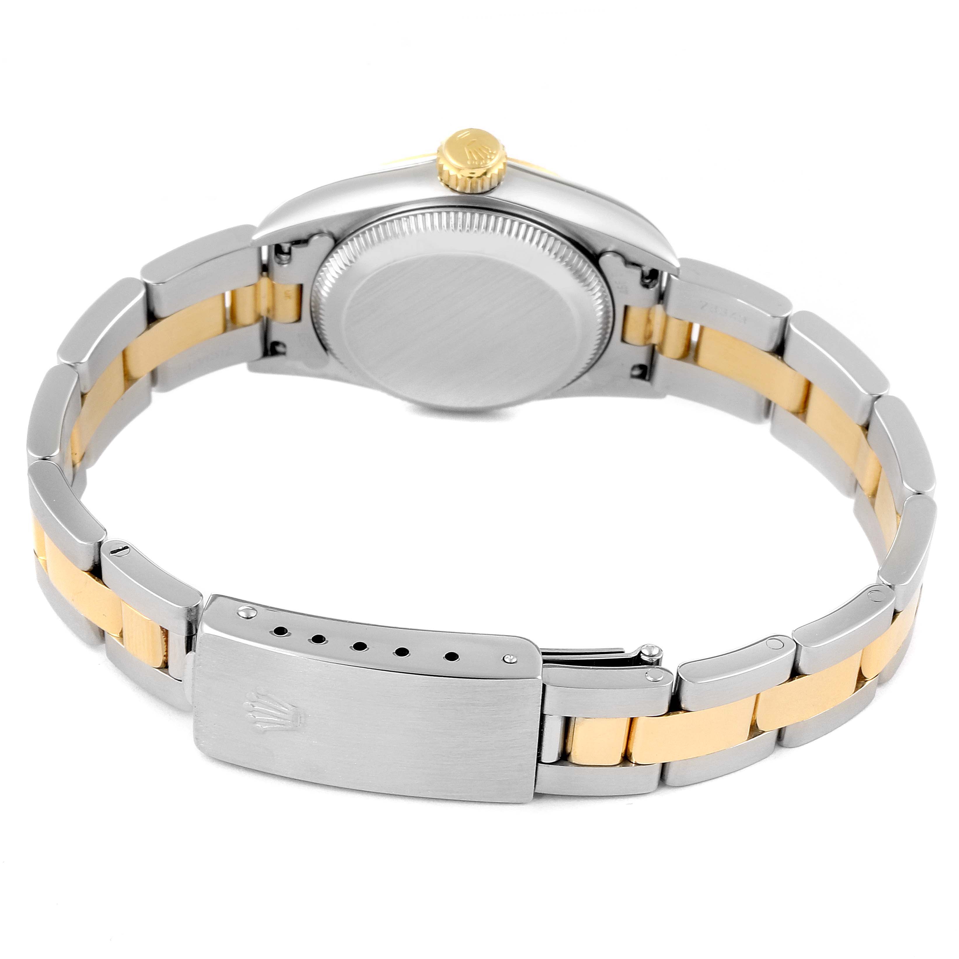 The image shows the back view of a Rolex Oyster Perpetual 67193 Women
s Steel and Gold (two tone) Champagne Dial 67193 Women
s Steel and Gold (two tone) Champagne Dial watch, including its clasp, bracelet, and case back.