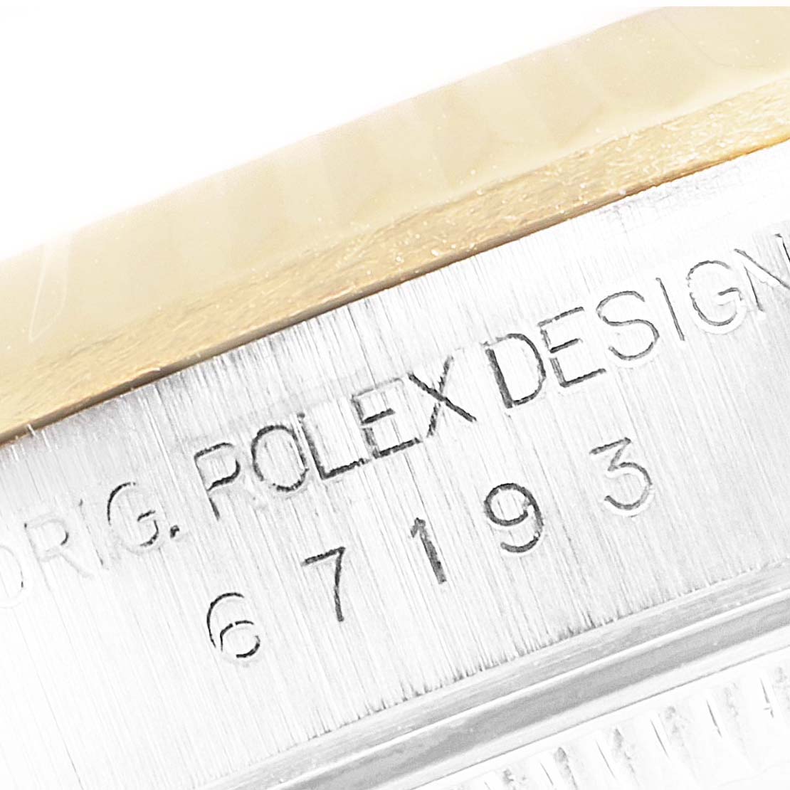 This close-up angle shows the engraved side of the Rolex Oyster Perpetual 67193 Women
s Steel and Gold (two tone) Champagne Dial 67193 Women
s Steel and Gold (two tone) Champagne Dial watch case.