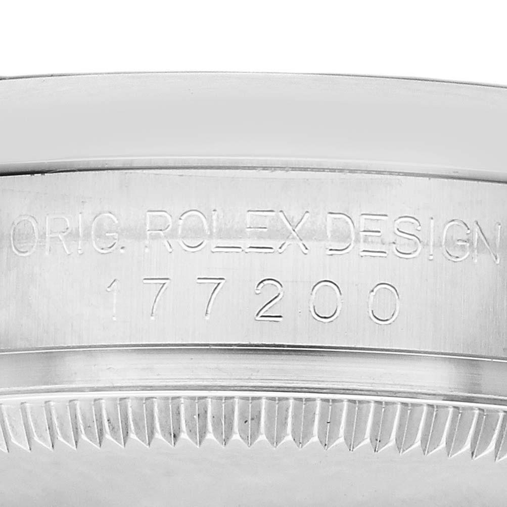 The image shows a close-up of the engraved case side of a Rolex Mid-Size 177200 Women's Stainless Steel Purple Dial watch, highlighting its model number and bezel edge.