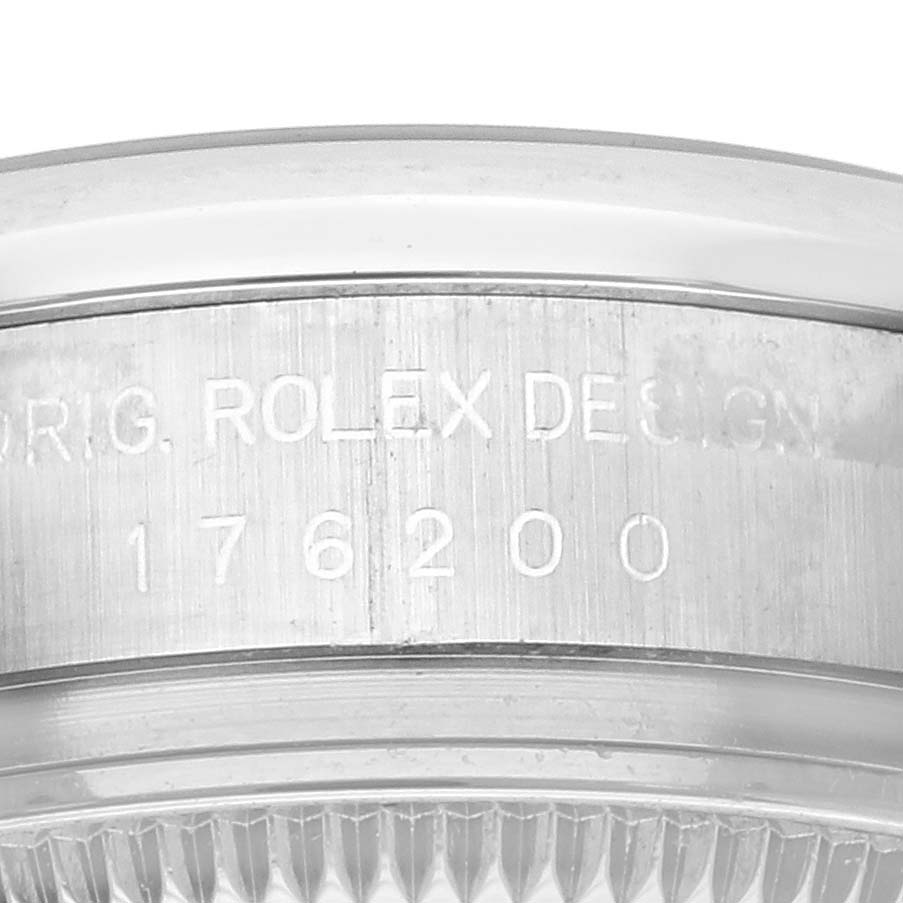 The image shows a close-up of the side of a Rolex Oyster Perpetual 176200 Women's Stainless Steel Silver Dial 176200 Women's Stainless Steel Silver Dial watch with engraving details.