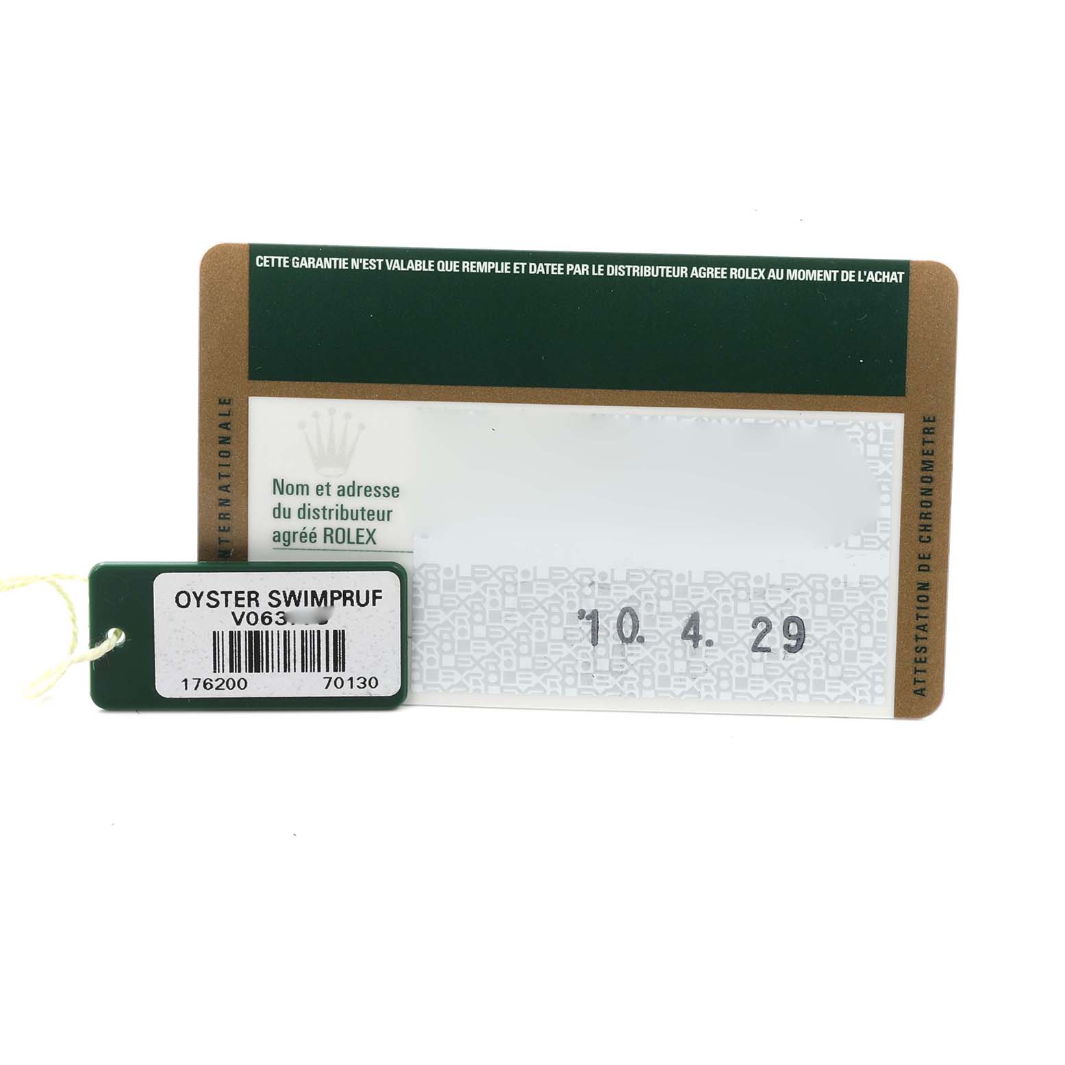 The image shows a warranty card and tag for the Rolex Oyster Perpetual 176200 Women's Stainless Steel Silver Dial 176200 Women's Stainless Steel Silver Dial model, focusing on accessories.