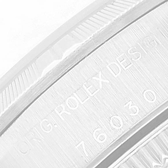 This image shows a close-up of the engraved serial and model numbers on the case side of a Rolex Oyster Perpetual 76030 Women's Stainless Steel Pink Dial 76030 Women's Stainless Steel Pink Dial watch.