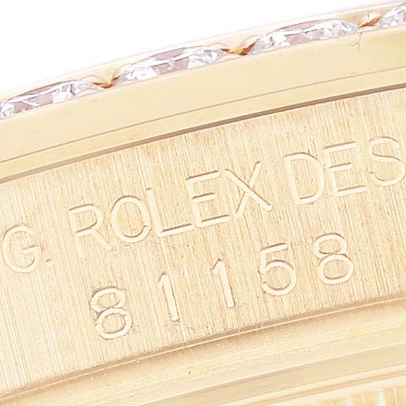 This close-up image shows part of the bezel with diamonds and engraved serial number on a Rolex Pearlmaster 81158 Women's Yellow Gold Mother of Pearl Dial 81158 Women's Yellow Gold Mother of Pearl Dial watch.