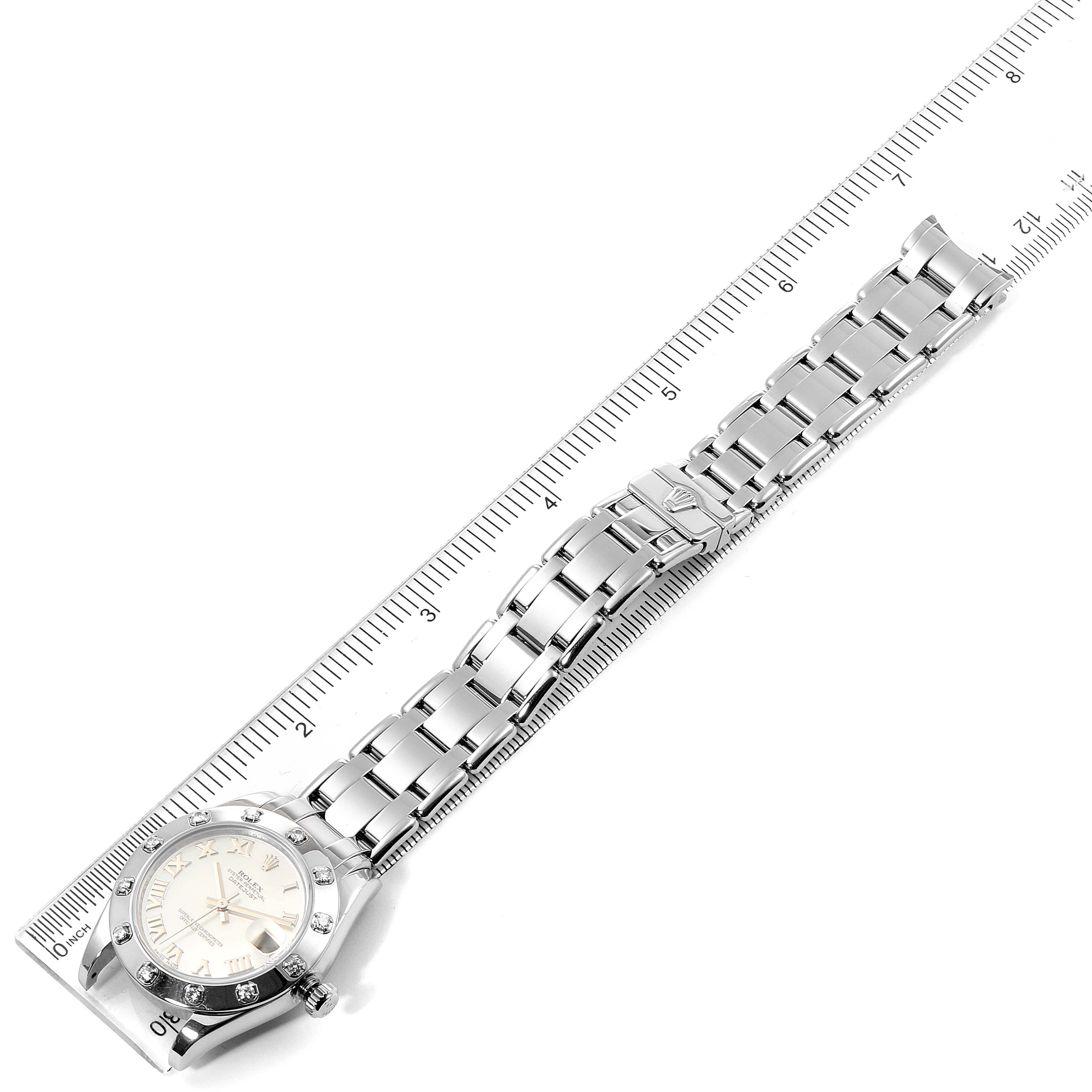 The Rolex Pearlmaster 81319 Women's White Gold Mother of Pearl Dial 81319 Women's White Gold Mother of Pearl Dial watch is photographed from a top-down angle, showing the face, bezel, and full bracelet alongside a ruler.