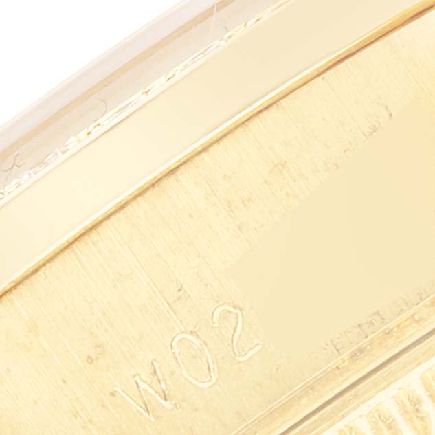 The image shows a close-up angled view of the gold case back of a Rolex President 69158 Women
s Yellow Gold Champagne Dial 69158 Women
s Yellow Gold Champagne Dial model watch.