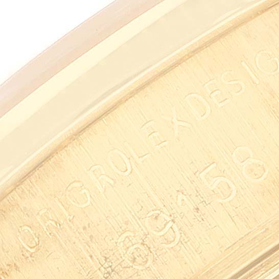 The image shows a close-up view of the engraved caseback side of a Rolex President 69158 Women
s Yellow Gold Champagne Dial 69158 Women
s Yellow Gold Champagne Dial model watch.