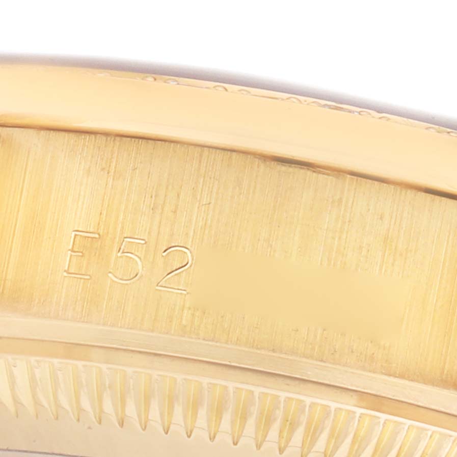 The image shows a close-up of the side of the bezel and case with engraving on the Rolex President 69158 Women's Yellow Gold Champagne Dial watch.