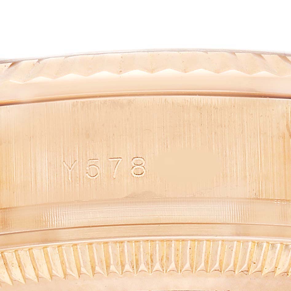 This image shows the side view of a Rolex President 179175 Women's Rose Gold Pink Dial watch, focusing on the engraved bezel and part of the case.