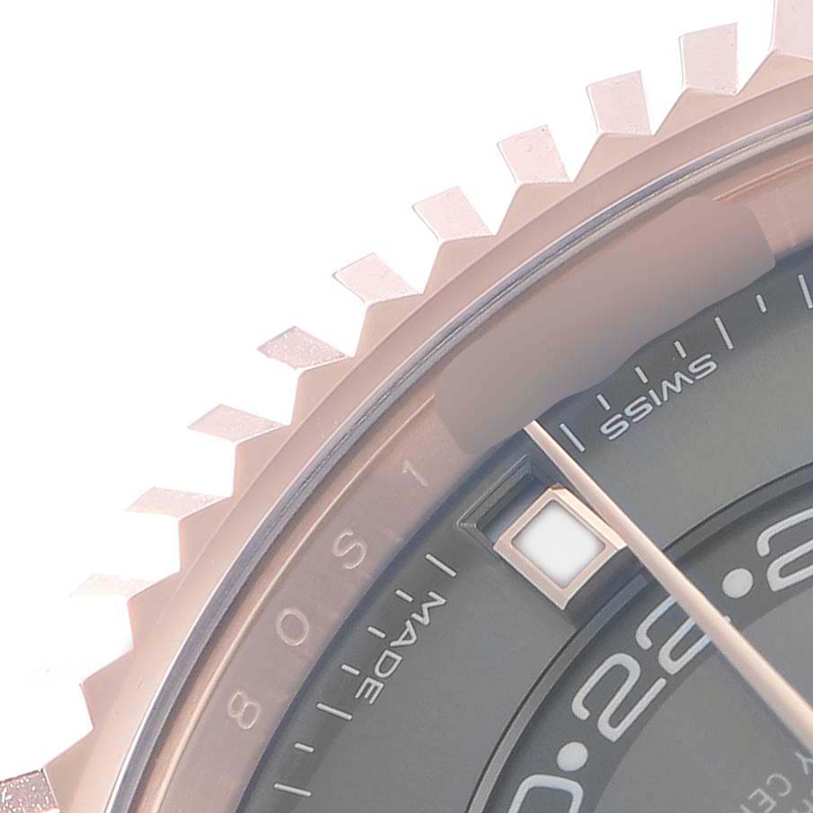 The image shows a close-up of the edge and bezel of a Rolex Sky-Dweller 326935 Men's Rose Gold Grey Dial watch, highlighting part of the dial and markings.