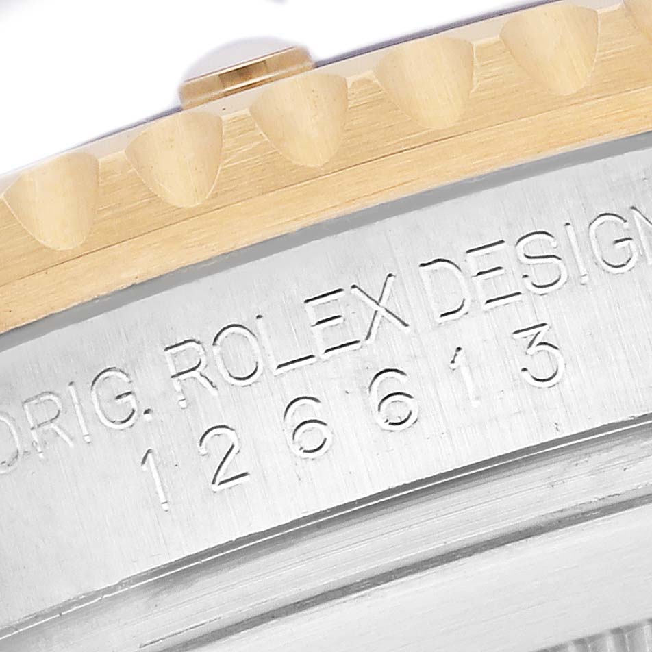 The image shows a close-up of the side of a Rolex Submariner 126613LB Men's Steel and Gold (two tone) Blue Dial 126613LB Men's Steel and Gold (two tone) Blue Dial, focusing on the engraved watch model number and part of the bezel.