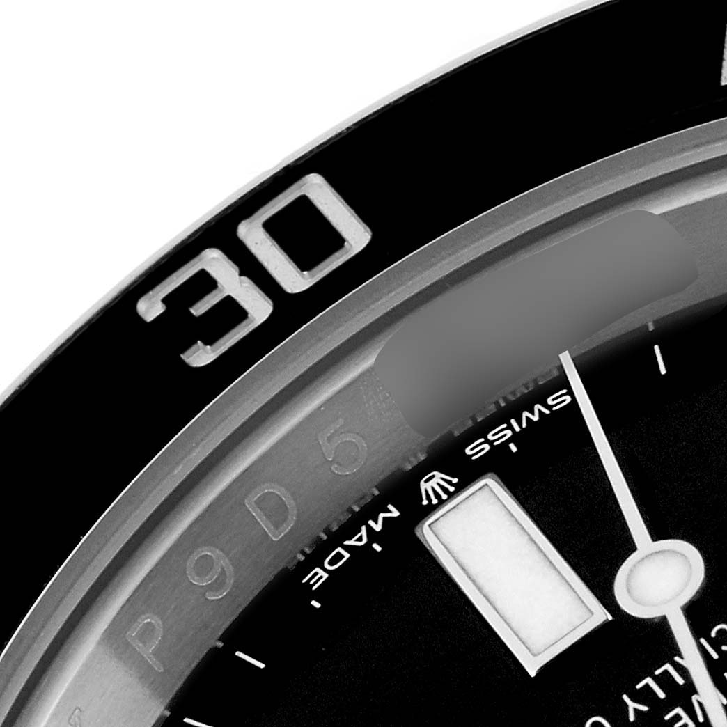 This close-up image of a Rolex Submariner 126610LN Men
s Stainless Steel Black Dial 126610LN Men
s Stainless Steel Black Dial watch shows the bezel, part of the dial, and the second hand.