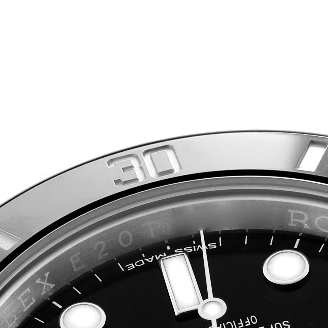 The image shows a close-up angle of the bezel and part of the dial of a Rolex Submariner 114060 Men's Stainless Steel Black Dial watch.